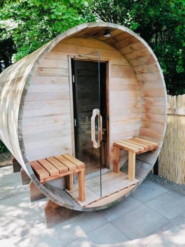 a small wooden sauna with two benches in it at Luxe schuurwoning 't Nieuwt in Chaam, Nederland in Chaam