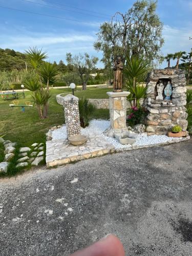 a fountain in a park with a statue at Villa Angela case vacanza in Vieste
