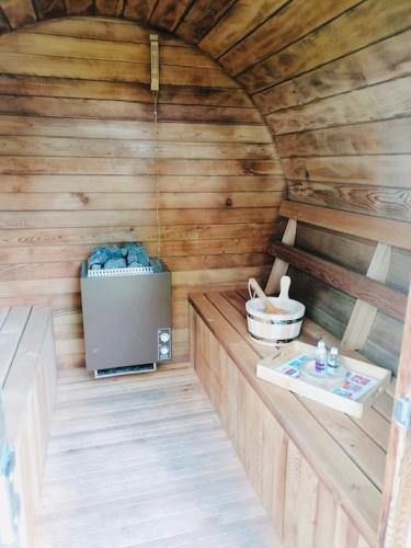 an inside view of a wooden cabin with a stove at Luxe schuurwoning 't Nieuwt in Chaam, Nederland in Chaam