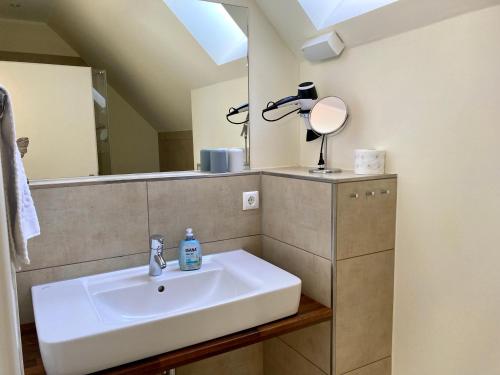 a bathroom with a sink and a mirror at Ferienhaus Grodenblick Strandflieder Whg. 2 in Wangerooge