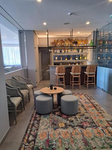 a lobby with chairs and a table and a bar at Villa Rey Spa & Hotel in Vila de Rei