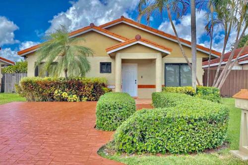 a house with a brick driveway in front of it at Tropical Oasis home w Community Pool great area in Kendall