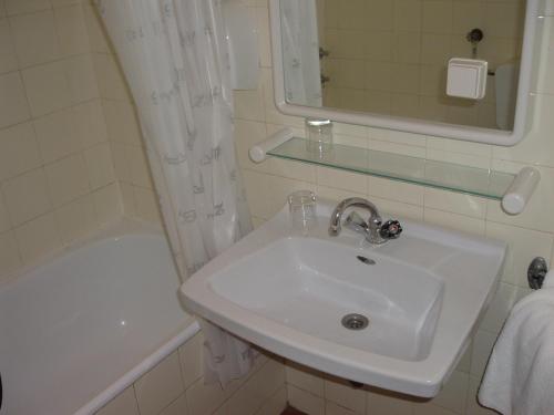 a bathroom with a sink and a bath tub at Depadansa Marina & Primorka in Omišalj