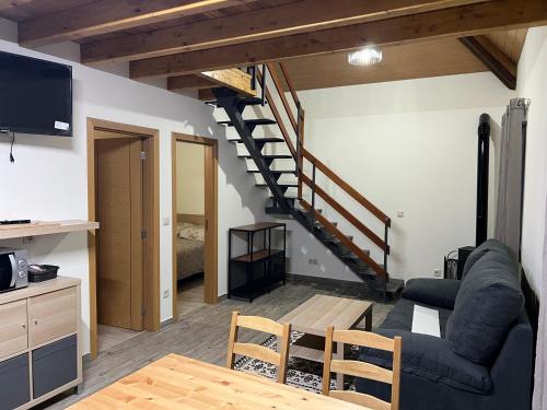 a living room with a couch and a staircase at Quinta da nogueira in Albergaria dos Doze