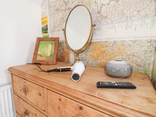 a mirror on top of a dresser with a remote control at Valley View in Ashbourne