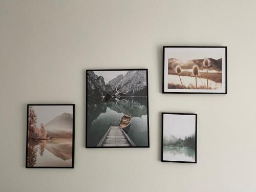 a group of four pictures hanging on a wall at Dream Apartments in Hohenems
