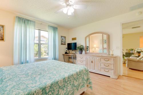 a bedroom with a bed and a dresser and a mirror at Lanai and Golf Cart The Villages Vacation Rental! in The Villages
