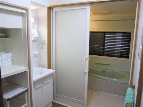 a bathroom with a shower and a sink and a tub at GuestHouse AZMO - Vacation STAY 84356v in Matsue