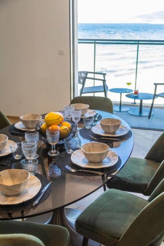 a table with bowls and plates of food on it at Résidence Côté Sud in LʼÎle-Rousse