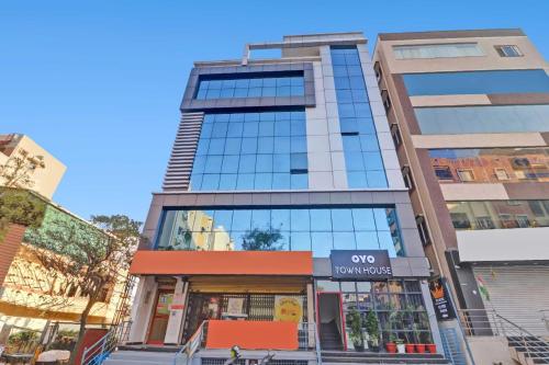 a tall building with a store in front of it at Super Townhouse Rcc Pride in Hyderabad