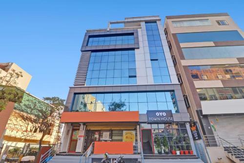a tall building with a store in front of it at Super Townhouse Rcc Pride in Hyderabad