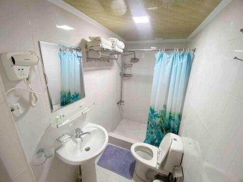 a bathroom with a sink and a toilet and a shower at Polvon Ota Hotel in Khiva