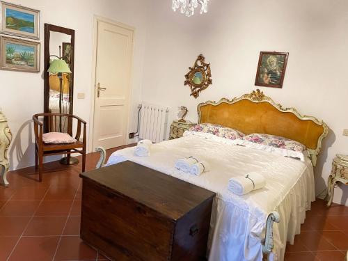 a bedroom with a large bed with two towels on it at 'Il Casale di Giova' Tuscan Farmhouse in Lucca