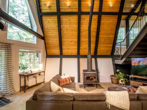 a living room with a couch and a fireplace at Alpine Lodge in Glacier