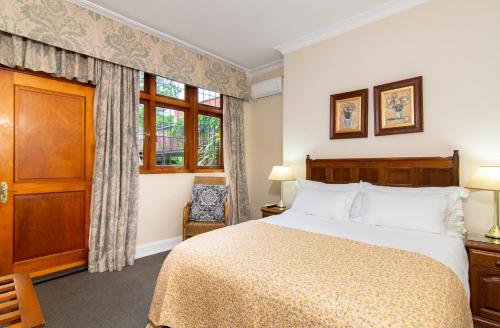 a bedroom with a bed and a window at Ridgeview Lodge in Durban