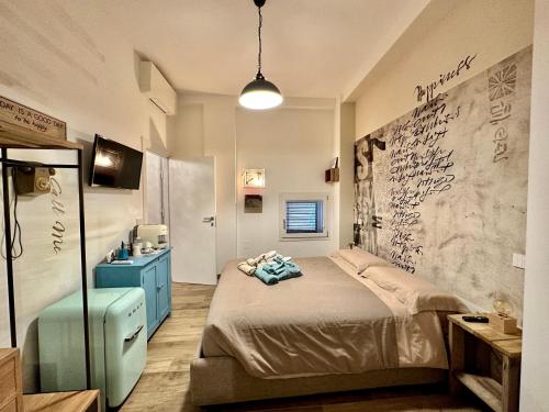 En eller flere senge i et værelse på Bed Art Relaxing Suite - Appartamento con Sauna Happiness Suite Gallery