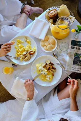 a group of people sitting at a table with plates of food at Hotel Du Pont in Wilmington