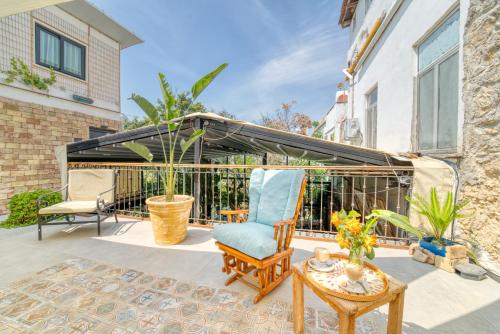 a patio with a chair and a table at The Port Of Kyrenia Hotel in Kérynia