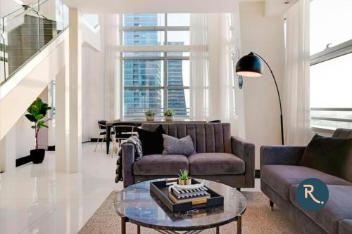 een woonkamer met 2 banken en een tafel bij Roami at Brickell Penthouse Squad Oasis in Miami