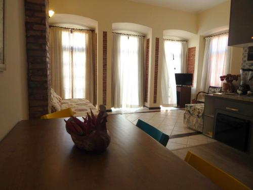 a kitchen with a table and a living room with windows at Solar do Carmo Suites & Apartments in Salvador