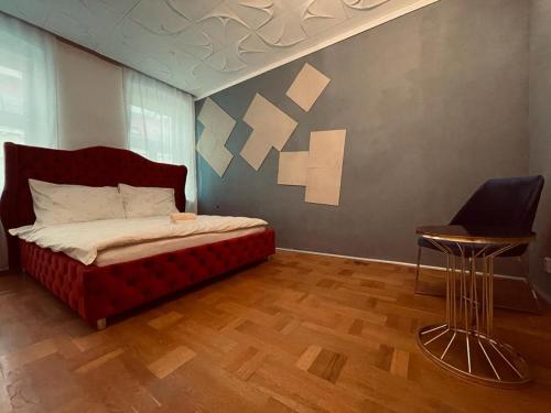a bedroom with a bed and a table and a chair at Sunrise Apartment in Vienna