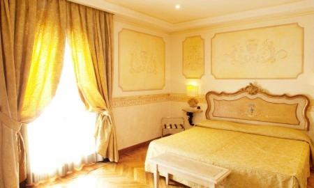 a bedroom with a bed and a large window at Hotel Villa San Pio in Rome