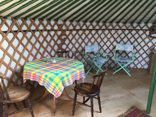 a table and chairs in a yurt at Higher Trenear Farm Yurts in Helston