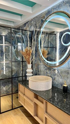 a bathroom with a sink and a mirror at Anastasia Princess Luxury Beach Residence, Adults Only in Perissa