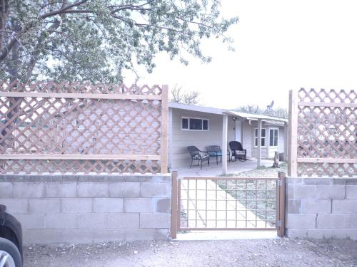 a fence with a gate in front of a house at 3 Bedroom By River Park & Trails in Loveland
