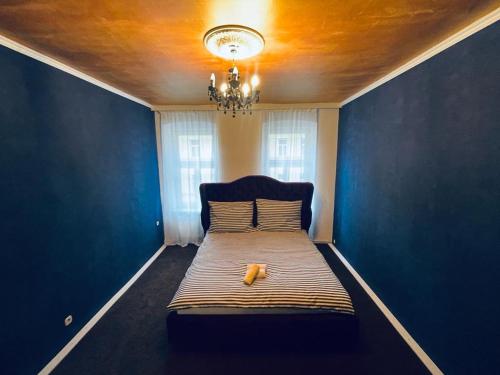 a blue room with a bed with a yellow object on it at Blaue Lagune in Vienna