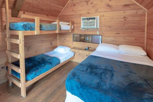 a bedroom with two bunk beds in a cabin at Sun Outdoors Pigeon Forge in Sevierville