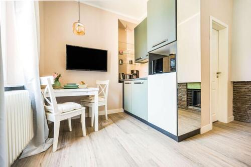 a kitchen and dining room with a table and a refrigerator at Entspannen in unserer gemütlichen Suite A in Bad Camberg