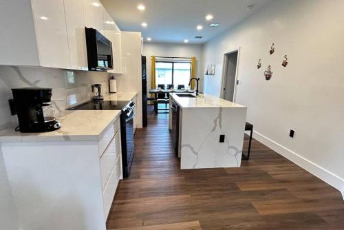 a kitchen with white cabinets and a counter top at Sunny Delight Home Near Airport in Hollywood