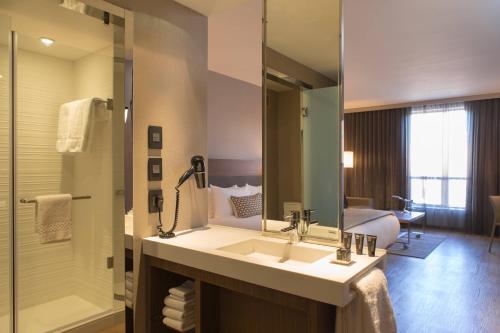 a bathroom with a sink and a shower at AC Hotel Kansas City Plaza in Kansas City