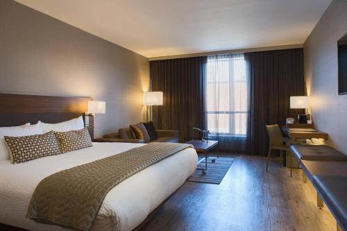 Un pat sau paturi într-o cameră la AC Hotel Kansas City Plaza