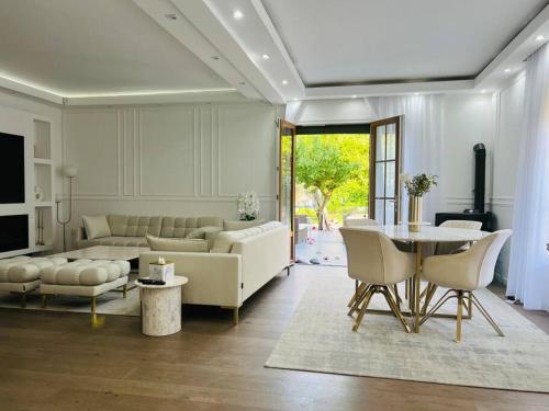 a living room with a couch and a table at Superbe maison avec jardin in Ris-Orangis