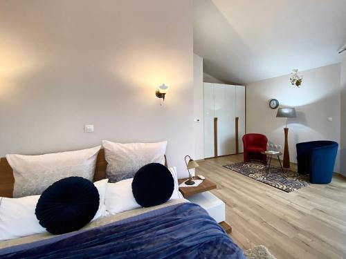 a bedroom with a bed and a red chair at Apartments Terra Solaris in Medulin