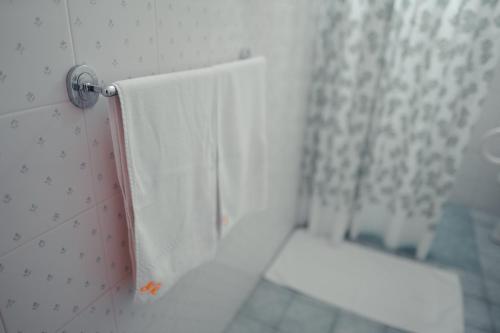 a bathroom with a shower with a white shower curtain at Savoia Residence in Acireale