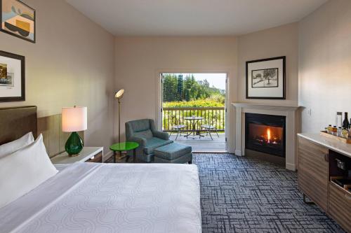 a hotel room with a bed and a fireplace at The Lodge at Sonoma Resort, Autograph Collection in Sonoma