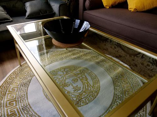 a glass coffee table with a bowl on top of it at Stunningly Opulent Gold Apartment Near Sheffield FULL SKY TV in Rotherham