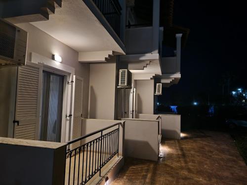 a balcony of a house at night with lights at Cavo Garden in Kavos