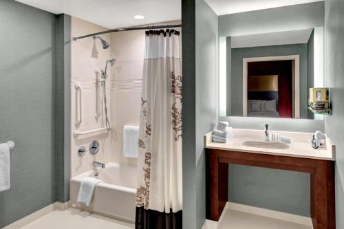 a bathroom with a tub and a sink and a shower at Residence Inn by Marriott Philadelphia Airport in Philadelphia