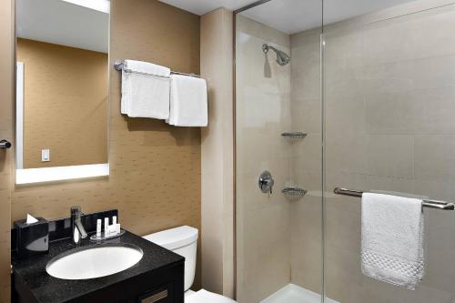 a bathroom with a shower and a sink and a toilet at Fairfield Inn & Suites by Marriott New York Manhattan/Chelsea in New York