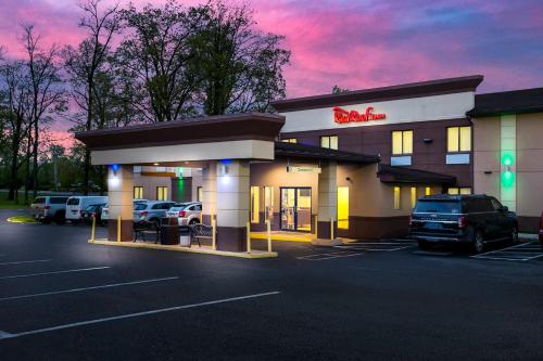 a mobil gas station with cars parked in a parking lot at Red Roof Inn Denver in Denver