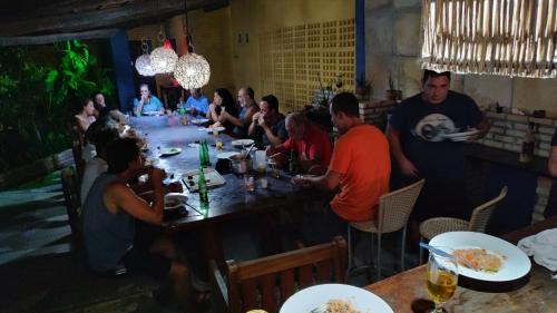 a group of people sitting at a table in a restaurant at Pousada La Luna in Paracuru