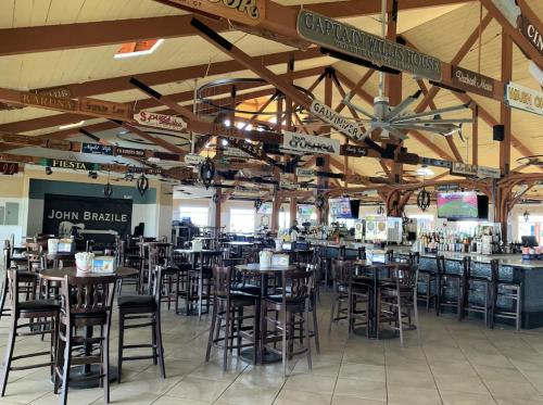 a dining room with tables and chairs in a restaurant at Ballard's Beach Resort in New Shoreham