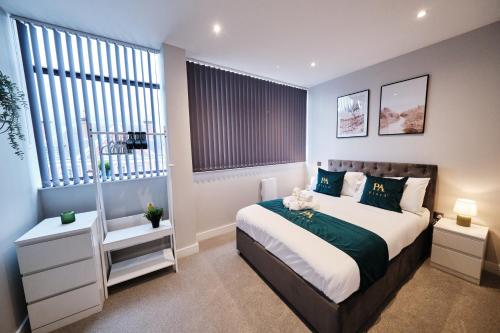 a bedroom with a large bed and two windows at Pluxa Jade - Prime Harrow, Work Desk & WiFi in Harrow