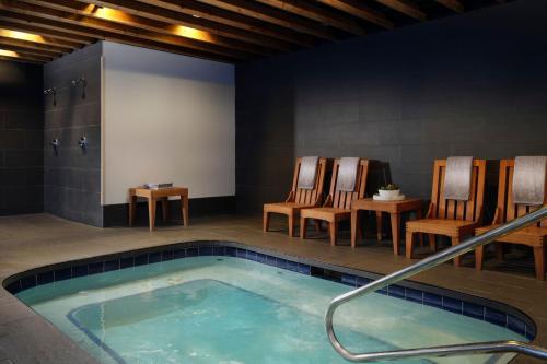 a hot tub in a room with chairs and tables at Renaissance Minneapolis Bloomington Hotel in Bloomington