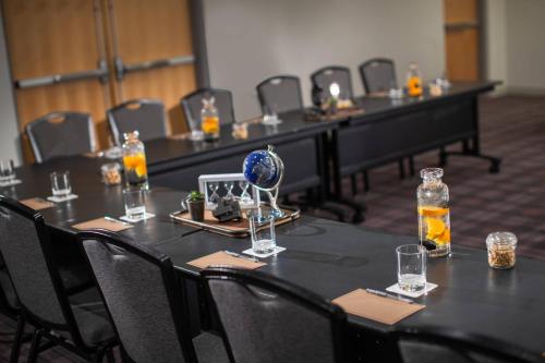 a row of tables in a room with glasses on them at Renaissance Minneapolis Bloomington Hotel in Bloomington