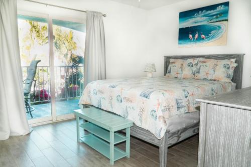 a bedroom with a bed and a view of the ocean at Island Club Turks & Grace Bay Place in Grace Bay